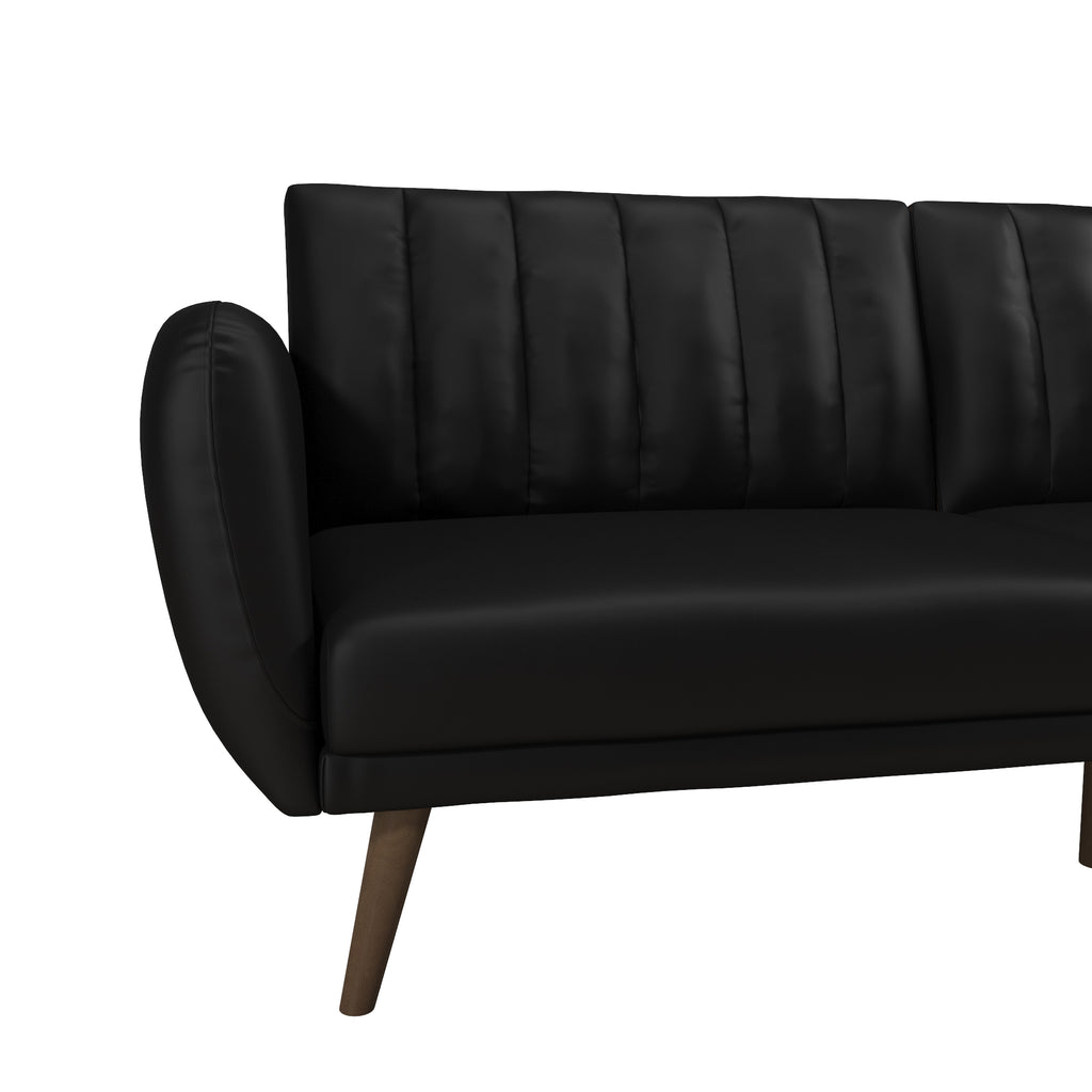 The Brittany Futon - Faux Leather is a black, modern sofa with vertical backrest stitching and smooth armrests. Its faux leather upholstery and multi-position split-back enhance its minimalist design, supported by four angled wooden legs for a sleek contemporary look.