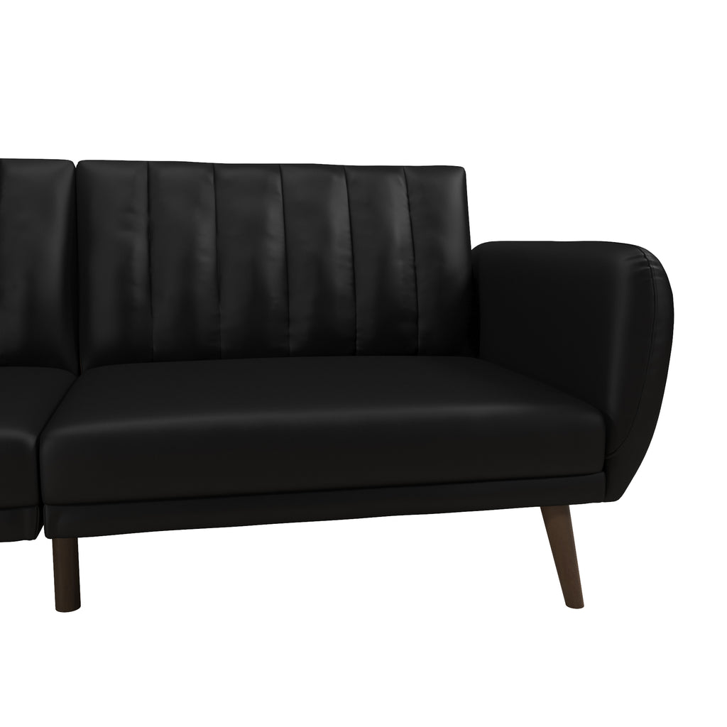 The Brittany Futon - Faux Leather is a modern piece with black faux leather upholstery, vertical stitching on the backrest, and wooden angled legs. Its minimalist design includes a multi-position split-back for flexibility, showcased from the right side.