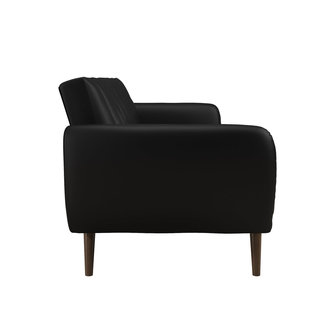 The Brittany Futon - Faux Leather features a sleek, black modern design with a cushioned backrest and seat in faux leather upholstery. Supported by four wooden legs, it offers a minimalist aesthetic ideal for contemporary interiors.