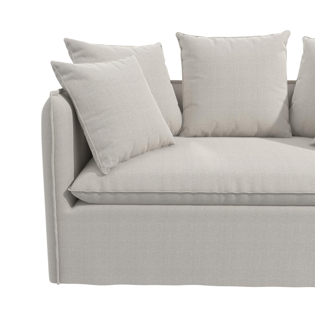 The Collette Slipcover Loveseat Sofa is light gray with a minimalist design. It features high-density foam seating and comes with four large square cushions set against a plain background, offering both comfort and easy maintenance with its soft fabric finish and removable slipcover.