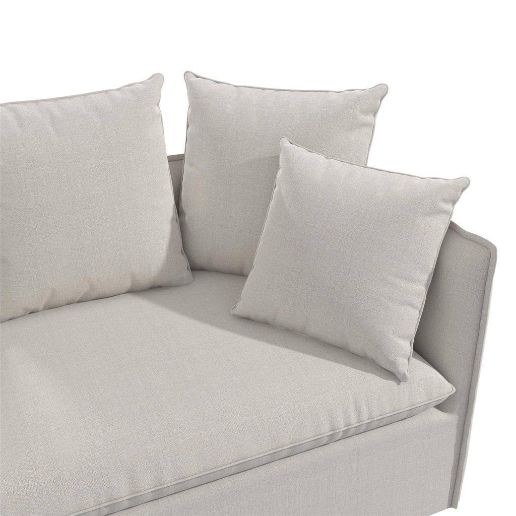 The Collette Slipcover Loveseat Sofa showcases a light gray design with two large square cushions and one smaller cushion, all made from high-density foam for comfort. Its clean lines and neutral tones establish a modern look, while plush cushions ensure an inviting feel.