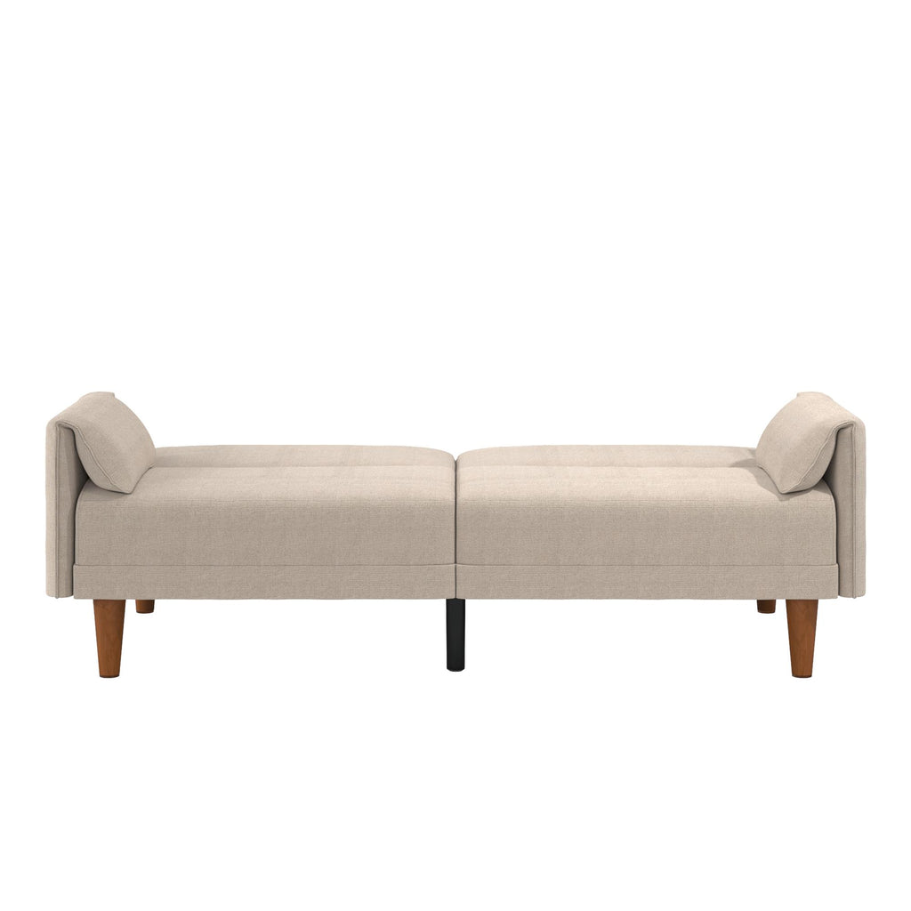 The Markham Futon is a light beige daybed with a modern, minimalist Scandinavian design, featuring wooden legs and cushioned backrests on each side. Its clean, contemporary style makes it an ideal choice for any living room or lounge area.