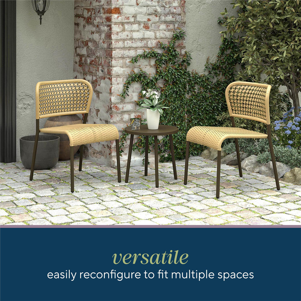 Outdoor patio scene with two Briar 3-Piece Wicker Chat Set chairs and a small round table on cobblestones, framed by a brick wall with plants. Text: Briar wicker chat set features a modern design and easy assembly for effortless reconfiguration in various spaces.