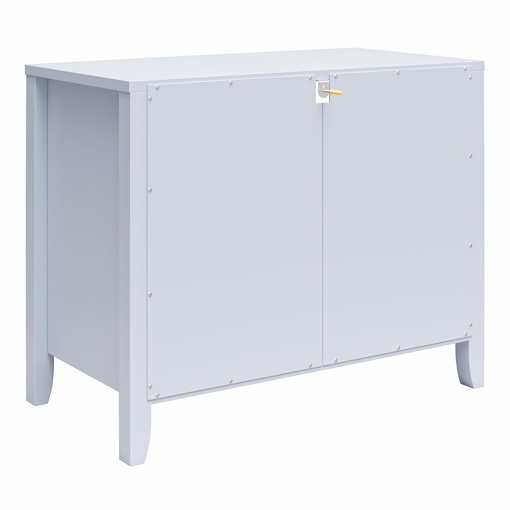 The Her Majesty 2 Drawer Nightstand by Novogratz is a light gray rectangular storage cabinet with two lockable doors. Its small legs elevate it slightly, enhancing its elegant style, while the smooth surface displays visible screws at the door edges.